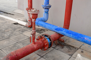 old grunge outdoor water connection pipe watering system connecting together rusty grungy weathered