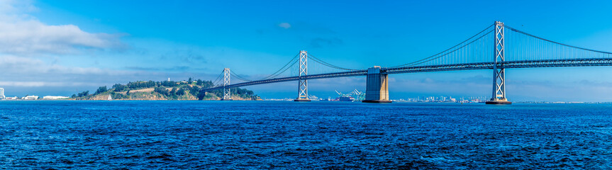 A panorama view from the Ferry Terminal Plaza towards the Oakland Bay bridge and Yerba Buena Island in San Francisco in early springtime