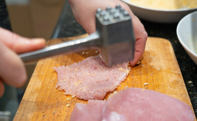 Tenderize meat, beating, hammering fillet pieces, cooking schnitzel process closeup