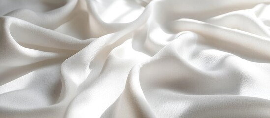 Obraz premium Elegant white satin fabric draped in soft folds creating smooth waves with subtle light reflections enhancing the silky texture and depth.