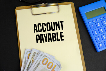 Business concept. Paper with text ACCOUNT PAYABLE , near calculator and cash money. 