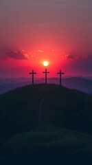 Three crosses silhouetted against a vibrant sunset on a hilltop.