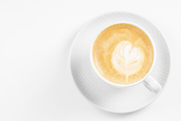 Hot coffee latte or cappuccino spiral foam in ceramic cup on white background, top view