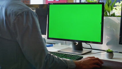 Unknown freelancer working green screen computer in modern workplace closeup