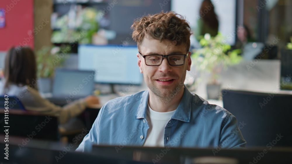 Poster smiling programmer working computer corporate workplace closeup. man looking pc