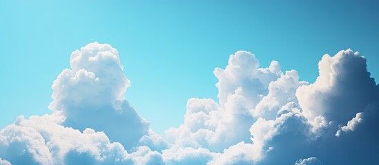 Bright blue sky with fluffy white clouds positioned prominently, creating a serene and peaceful atmosphere ideal for nature visuals.
