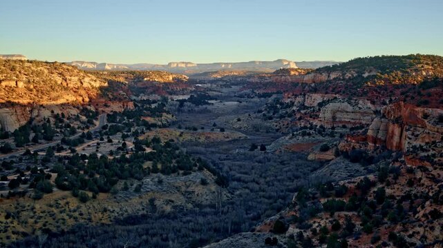 Drone soars above deep canyons near Kanab, Utah, as the first light of day emerges.