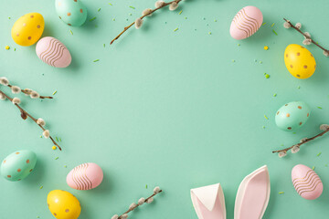 A festive Easter-themed composition with colorful decorated eggs and bunny ears against a pale...