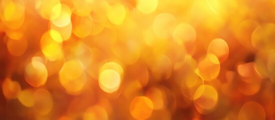 Warm golden bokeh background featuring vibrant orange hues with blurred circular lights creating a serene autumnal atmosphere and soft sunbeams.