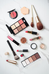 Make up products at white marble background.
