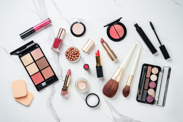 Make up products at white marble background.