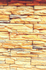 Sandstone wall made of light yellow bricks, sandstone wall background