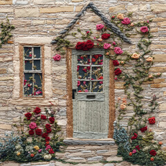 beautiful embroidered wall featuring door and windows adorned with colorful flowers, showcasing intricate textile art and craftsmanship