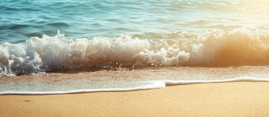 Gentle turquoise sea waves lapping on soft golden sandy beach under warm sunlight creating a serene vintage holiday backdrop with ample copyspace