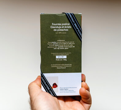 Paris, France - Feb 17, 2025: The back label of a Henner Freres chocolate bar details the praline gianduja filling with pistachio pieces, listing ingredients and storage instructions