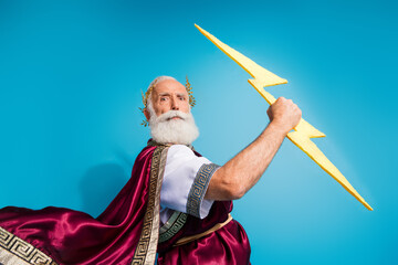 Photo of attractive old man hold catch storm lightning dressed greek god emperor actor costume...