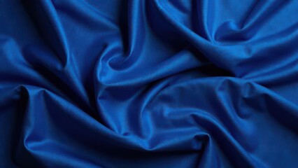 Obraz premium Richly colored satin fabric in a deep blue hue is elegantly arranged with soft flowing folds. The texture and sheen create a luxurious appearance that captivates the eye.