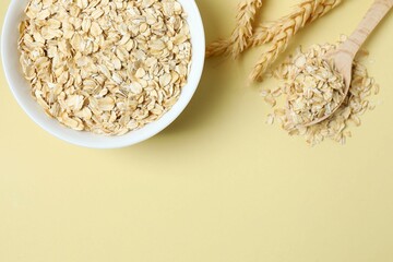 Composition with oatmeal flakes on gray background. Cooking breakfast