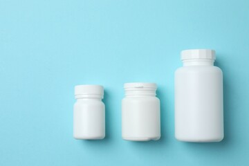 White bottles on blue background, top view