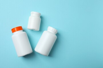 White bottles on blue background, top view