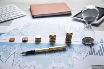 Stack of coins with a financial growth graphs.