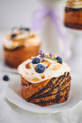 Traditional Easter cakes on festive table decorated with fresh flowers and colorful painted Easter eggs.