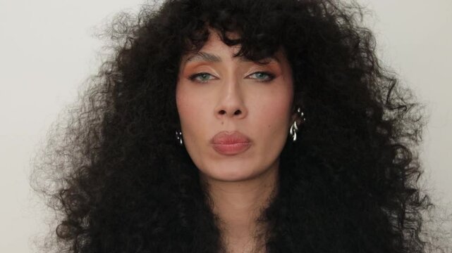 video of a Latina woman applying lipstick
