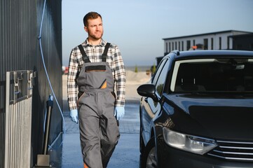 Portrait of a car wash station worker.