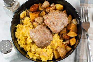 sausage patties with scramble eggs and home fries