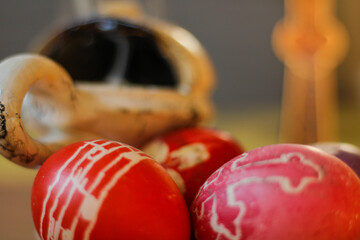 Easter eggs next to the censer and cross.