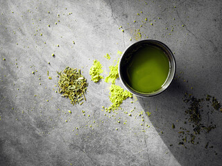Matcha Green tea drink in tea cup and Japanese dry green tea leaves for health brewing with soft...