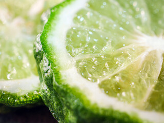 Macro of slices bergamot fruit  on black background, close-up of slices bergamot © NARONG