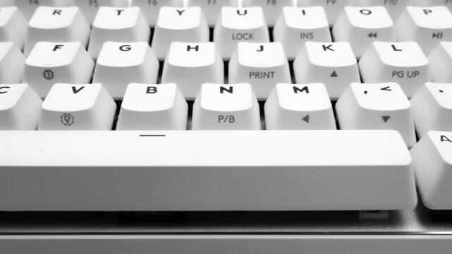 Slow motion, white, wireless gaming mechanical computer keyboard. Closeup of keys. Minimal, modern design on white background. 60 percent keyboard. Copy space. Communication device.