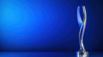 sleek silver trophy with twisting design against blue background
