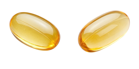 Two yellow gelatin capsules on a black background.