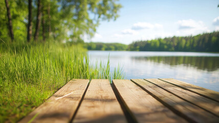 serene lakeside view featuring wooden dock, lush green grass, and calm water