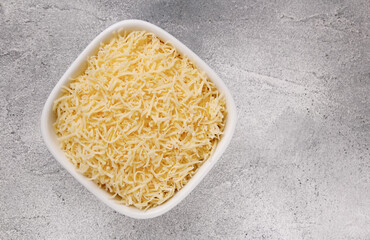 Heap of grated delicious cheese. Concept: Italian cuisine, cheese, restaurant, and food.