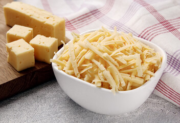 Heap of grated delicious cheese. Concept: Italian cuisine, cheese, restaurant, and food.