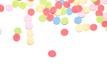 Close up of sugar paper confetti circle spots and colour dots on white background