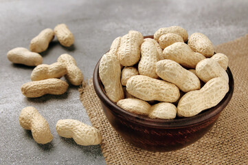 Organic Raw Peanuts in a Bowl on grey table