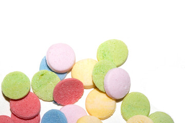 Close up of sugar paper confetti circle spots and colour dots on white background