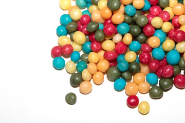 Close up of round ball sugar ice cream cake decorations on a white background