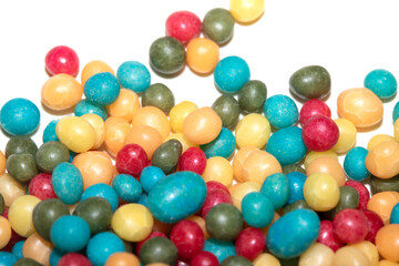 Close up of round ball sugar ice cream cake decorations on a white background
