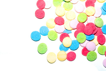 Close up of sugar paper confetti circle spots and colour dots on white background