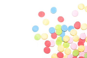 Close up of sugar paper confetti circle spots and colour dots on white background