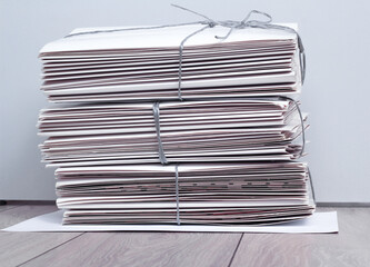 A stack of paper tied with a rope lies on the floor in the office. Recycling, reuse, ecology