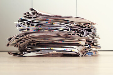a stack of newspapers. a lot of paper in a pile. Ready for recycling