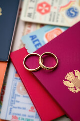 romantic honeymoon adventure: two gold wedding bands on travel documents concept of love, journey, marriage