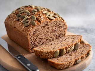 Freshly baked bread with sesame and pumpkin seeds, sliced and ready to enjoy.
