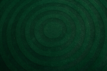 A stylish round rug in a deep green color with a geometric pattern. Perfect for creating a cozy atmosphere in any interior.